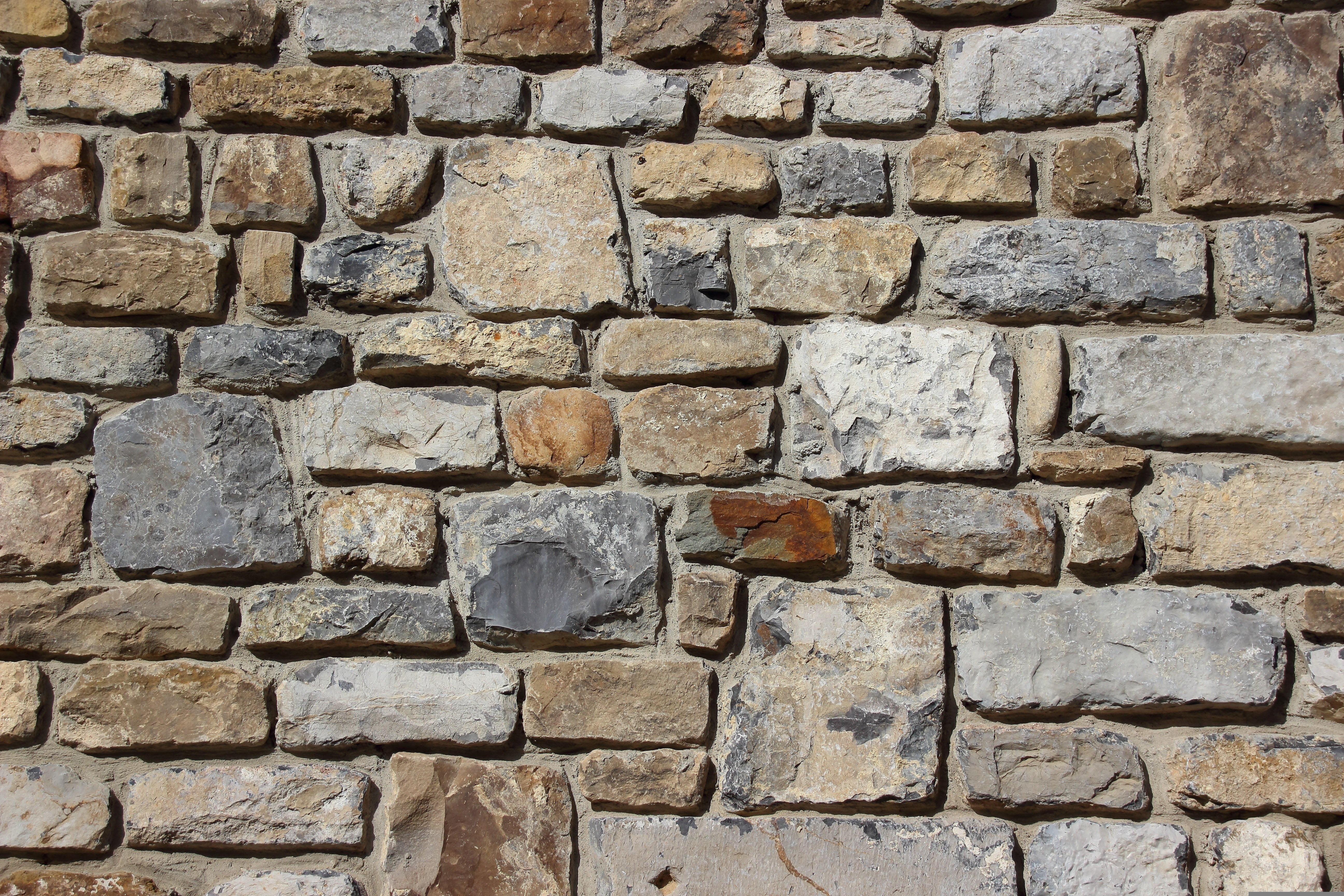 A wall made from individual blocks of stone with mortar in between.