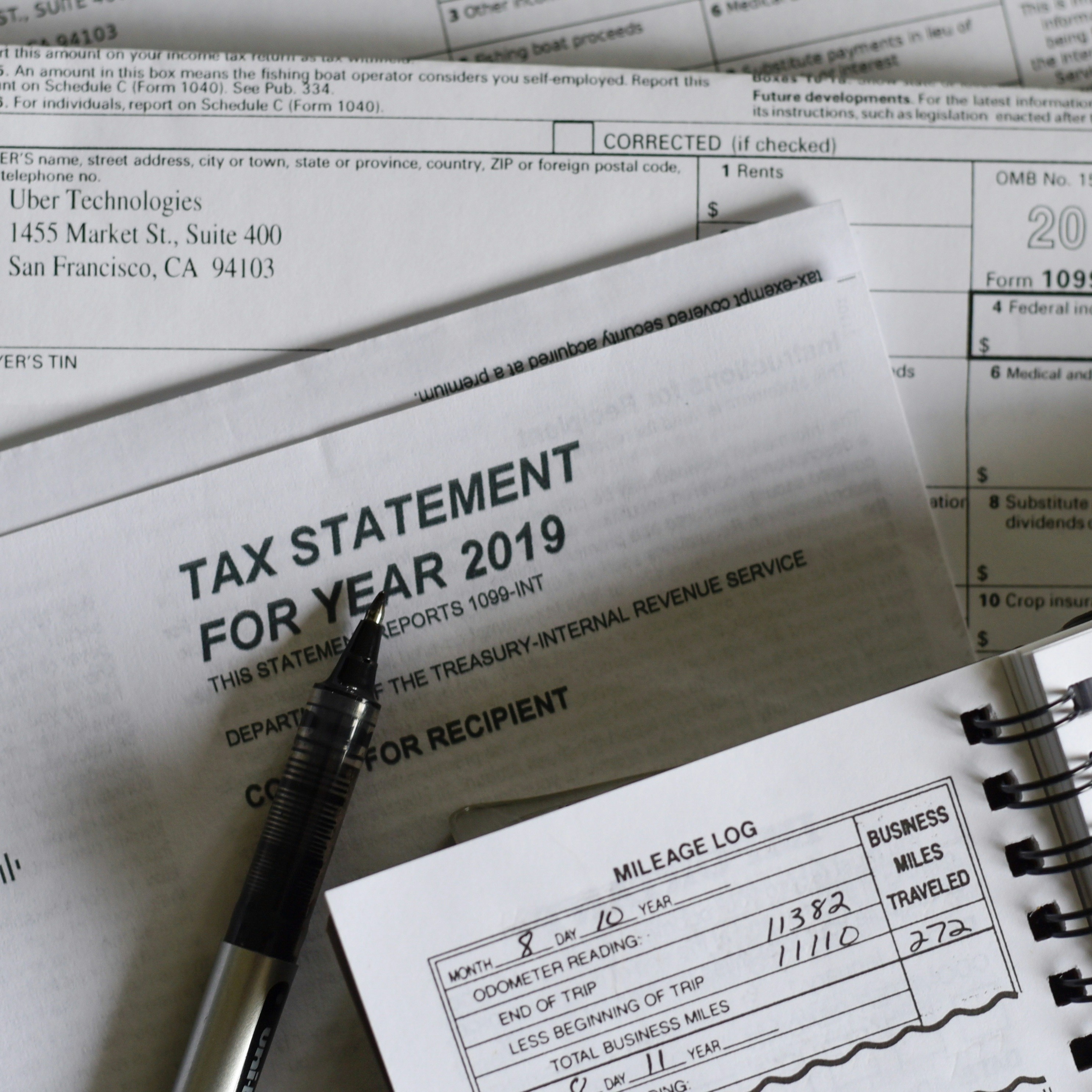 A photo of a stack of papers. The top sheet reads "Tax statement for year 2019."