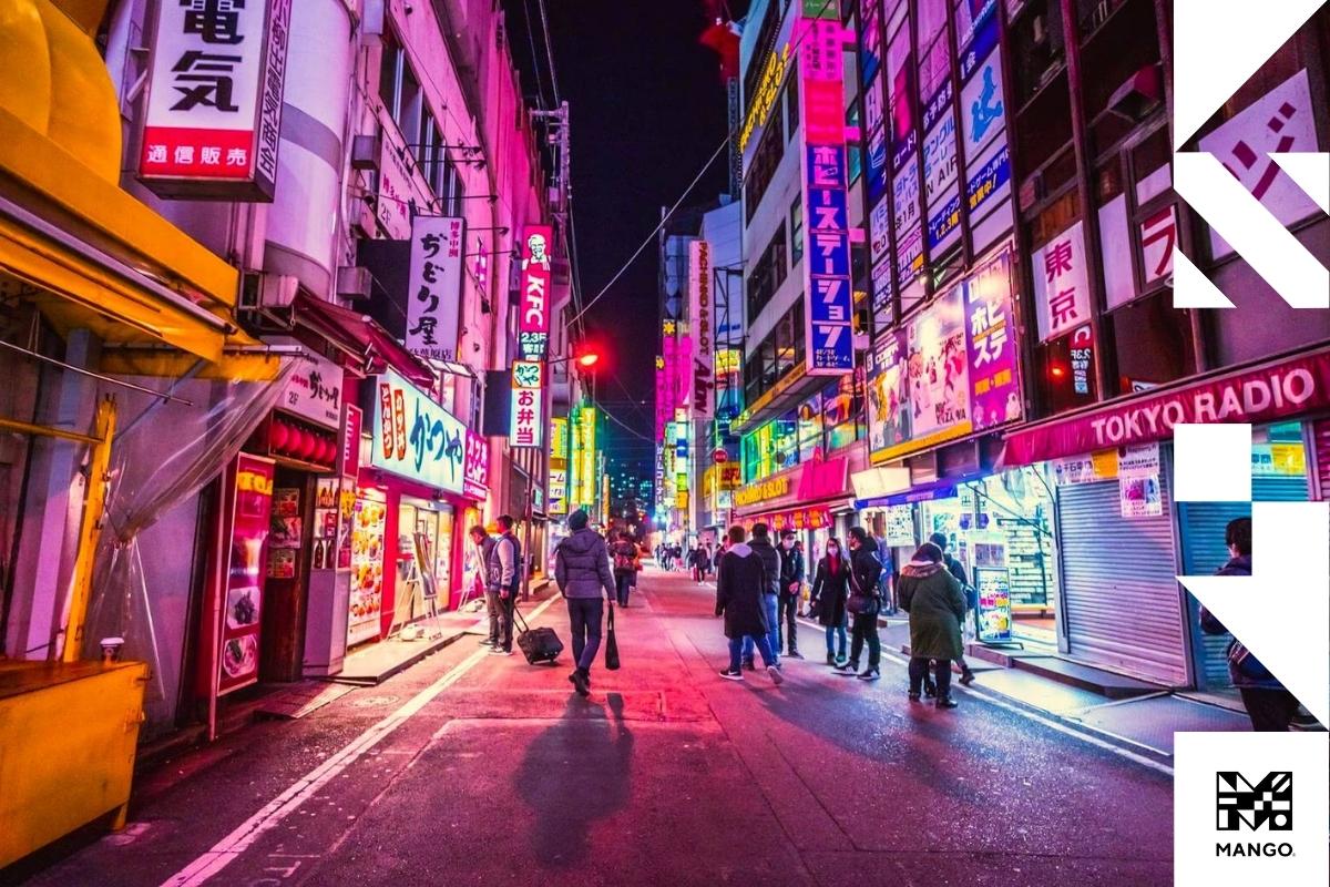 A busy Japanese city street filled with stores and signs
