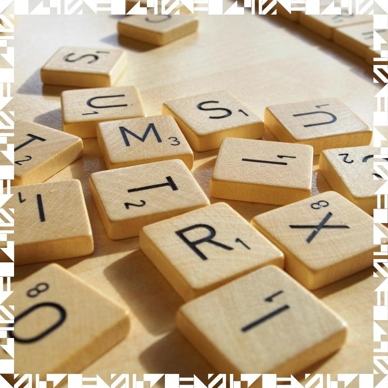 A bunch of scrabbles tiles scattered across a table